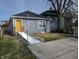 Home exterior with a ramp leading to a bright yellow door, ensuring accessibility at 3636 Salem St, Indianapolis, IN 46208
