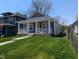 Quaint home with a covered front porch, a well-manicured lawn, and mature trees at 3636 Salem St, Indianapolis, IN 46208