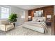 Inviting bedroom with brick accent wall, neutral tones, and a comfortable chair, creating a relaxing atmosphere at 610 N Park Ave, Indianapolis, IN 46204