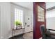 Bright entryway with white walls, glass block window, dark wood floors, and a stylish accent table at 610 N Park Ave, Indianapolis, IN 46204