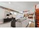 Open living room with hardwood floors, modern decor, exposed ductwork, and stairs leading to the next floor at 610 N Park Ave, Indianapolis, IN 46204