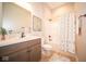 Bathroom featuring a vanity with sink, toilet, and shower/tub combination with decorative curtain at 7936 Beaumont Green Pl, Indianapolis, IN 46250