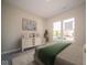 Bright bedroom with a dresser, two large windows, and a comfortable bed with a green throw at 7936 Beaumont Green Pl, Indianapolis, IN 46250