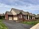 Beautiful brick home with attached two-car garage and manicured landscaping at 7936 Beaumont Green Pl, Indianapolis, IN 46250
