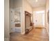 Inviting foyer with a custom built-in bench and storage, leading to a bedroom and the front door at 7936 Beaumont Green Pl, Indianapolis, IN 46250