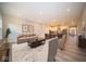 Spacious living room with a fireplace and ample natural light, flowing into an open-concept kitchen at 7936 Beaumont Green Pl, Indianapolis, IN 46250