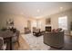 Cozy living room with fireplace, comfortable seating, and plenty of natural light from large windows at 7936 Beaumont Green Pl, Indianapolis, IN 46250