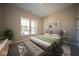 Well-lit bedroom offers a serene setting with a comfortable bed, soft lighting, and scenic views at 7942 Beaumont Green Pl, Indianapolis, IN 46250