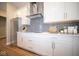 Updated kitchen features stylish backsplash, white cabinets, stainless steel refrigerator, and modern hardware at 7942 Beaumont Green Pl, Indianapolis, IN 46250