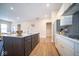 New kitchen features a central island with modern appliances, contrasting dark cabinets, and ample counter space at 7942 Beaumont Green Pl, Indianapolis, IN 46250