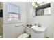 Bathroom featuring a standard toilet, sink, mirror and fixtures at 3612 Schofield Ave, Indianapolis, IN 46218