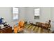 Bright bedroom with neutral walls, hardwood floors, and natural light from two windows at 3612 Schofield Ave, Indianapolis, IN 46218