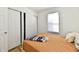 Bedroom featuring a cozy bed, neutral walls, wood-look floors, and closet at 3612 Schofield Ave, Indianapolis, IN 46218