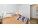 Bedroom featuring a cozy bed, neutral walls, and wood-look floors at 3612 Schofield Ave, Indianapolis, IN 46218