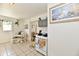 Bright eat-in kitchen with white subway tile, appliances, hanging plants, and gray cabinets at 3612 Schofield Ave, Indianapolis, IN 46218