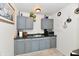 Efficient kitchen with gray cabinets, brick walls, tile floors, and stainless steel microwave at 3612 Schofield Ave, Indianapolis, IN 46218