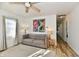 Cozy living room with wood floors, ceiling fan, large window, and couch at 3612 Schofield Ave, Indianapolis, IN 46218