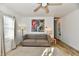 Bright living room with wood floors, ceiling fan, large window, couch, and decor at 3612 Schofield Ave, Indianapolis, IN 46218