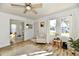 Open living room with wood floors, ceiling fan, natural light, view of dining area, and entry at 3612 Schofield Ave, Indianapolis, IN 46218