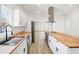 Modern kitchen with white cabinets, stainless steel appliances, and a large island at 1005 W 25Th St, Indianapolis, IN 46208