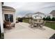 Spacious backyard patio with outdoor dining set, wicker furniture, and a well-maintained lawn at 6748 Fallen Leaf Dr, Whitestown, IN 46075
