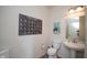 Cozy half bathroom featuring a pedestal sink, modern fixtures, and stylish wall art at 6748 Fallen Leaf Dr, Whitestown, IN 46075