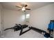 Functional bedroom with exercise equipment, ceiling fan, and neutral carpeting at 6748 Fallen Leaf Dr, Whitestown, IN 46075