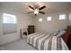 Cozy bedroom with a striped comforter, ceiling fan, and natural light from multiple windows at 6748 Fallen Leaf Dr, Whitestown, IN 46075