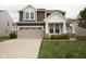 Charming two-story home featuring a two-car garage and a welcoming front porch at 6748 Fallen Leaf Dr, Whitestown, IN 46075