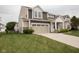 Charming two-story home featuring a two-car garage and a well-manicured lawn at 6748 Fallen Leaf Dr, Whitestown, IN 46075