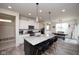 Open kitchen featuring a center island with granite countertops, pendant lighting, and stainless steel sink at 6748 Fallen Leaf Dr, Whitestown, IN 46075