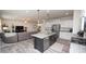 Bright kitchen with stainless steel appliances, large island, granite countertops, and view into living room at 6748 Fallen Leaf Dr, Whitestown, IN 46075