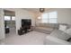 Comfortable living room with a gray sectional sofa, TV, and neutral carpeting at 6748 Fallen Leaf Dr, Whitestown, IN 46075