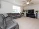 Spacious living room with a large gray sectional, ceiling fan, and a wall-mounted television at 6748 Fallen Leaf Dr, Whitestown, IN 46075