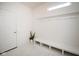 Clean mud room featuring a bench with hooks and storage, tile flooring, and a side entry door at 6748 Fallen Leaf Dr, Whitestown, IN 46075