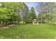 Expansive backyard with a well-maintained lawn, a playset, and a fenced perimeter for privacy and security at 11193 Harriston Dr, Fishers, IN 46037