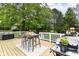 Outdoor deck with seating, a grill, and a view of the lush backyard, perfect for entertaining at 11193 Harriston Dr, Fishers, IN 46037