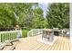 Inviting backyard deck with an outdoor table and seating, overlooking a spacious yard with a playset at 11193 Harriston Dr, Fishers, IN 46037