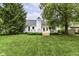 Large backyard featuring a well-manicured lawn, mature trees, and a view of the home's exterior at 11193 Harriston Dr, Fishers, IN 46037