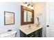 Cozy half bath featuring a rustic wood-framed mirror, stylish lighting, and modern fixtures at 11193 Harriston Dr, Fishers, IN 46037