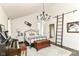 Stylish bedroom features high ceilings, a chandelier, and ladder accent for a unique touch at 11193 Harriston Dr, Fishers, IN 46037