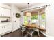 Charming dining area with modern chairs, a wooden table, and natural light from a bay window at 11193 Harriston Dr, Fishers, IN 46037