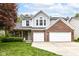 Charming two-story home boasts brick and gray siding, a well-manicured lawn, and a convenient two-car garage at 11193 Harriston Dr, Fishers, IN 46037