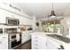 Updated kitchen showcasing white cabinetry, stainless steel appliances, and an eat-in breakfast area at 11193 Harriston Dr, Fishers, IN 46037