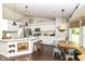 Well-lit kitchen with white cabinets, stainless steel appliances, and an adjacent dining area at 11193 Harriston Dr, Fishers, IN 46037