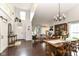 Open-concept living and dining area with high ceilings, dark wood floors, and modern decor at 11193 Harriston Dr, Fishers, IN 46037