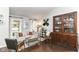 Comfortable living room features a cozy sofa, a decorative hutch, and bright windows with natural light at 11193 Harriston Dr, Fishers, IN 46037
