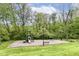 Community playground offering a playset, swing set, bench, and green space for recreational activities at 11193 Harriston Dr, Fishers, IN 46037
