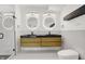 Modern bathroom with a double sink vanity, sleek black countertops, and stylish round mirrors at 1218 Orange St, Indianapolis, IN 46203