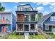 Modern three-story home with eye-catching design and balconies on the second and third floor at 1218 Orange St, Indianapolis, IN 46203